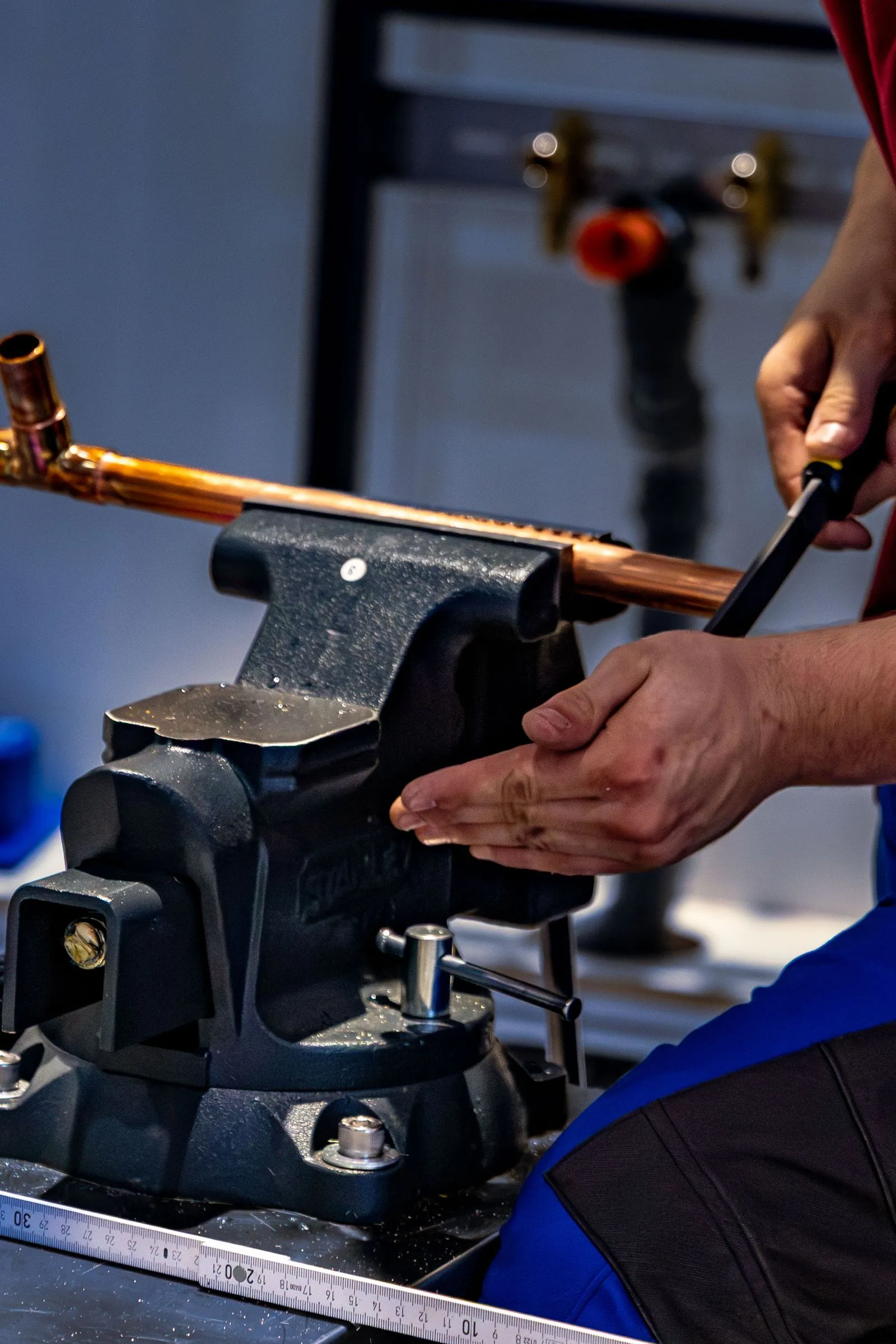 Plumber cutting copper pipe for a repipe
