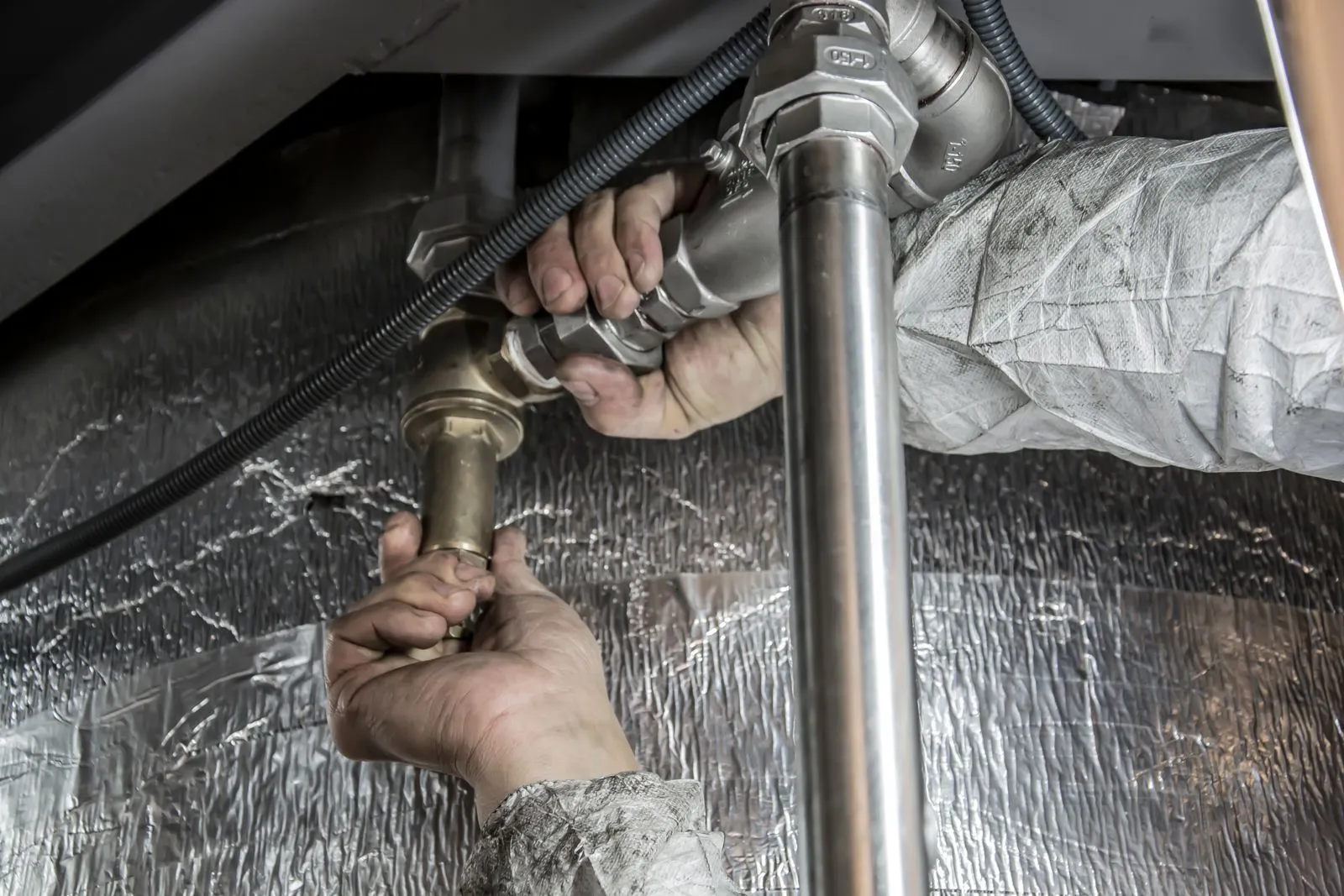 Plumber repairing a water pipe